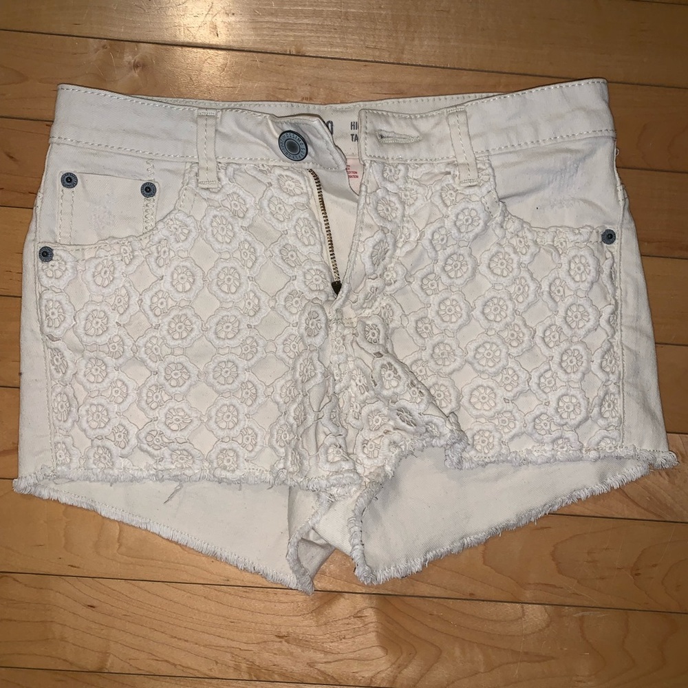 Cream colored jean shorts with lace design